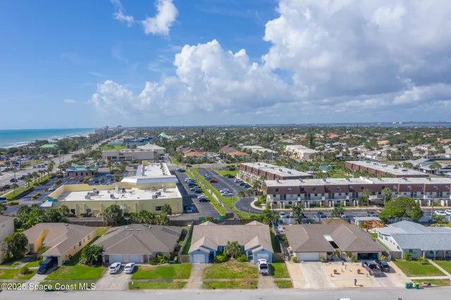 an aerial view of residential building and car parked