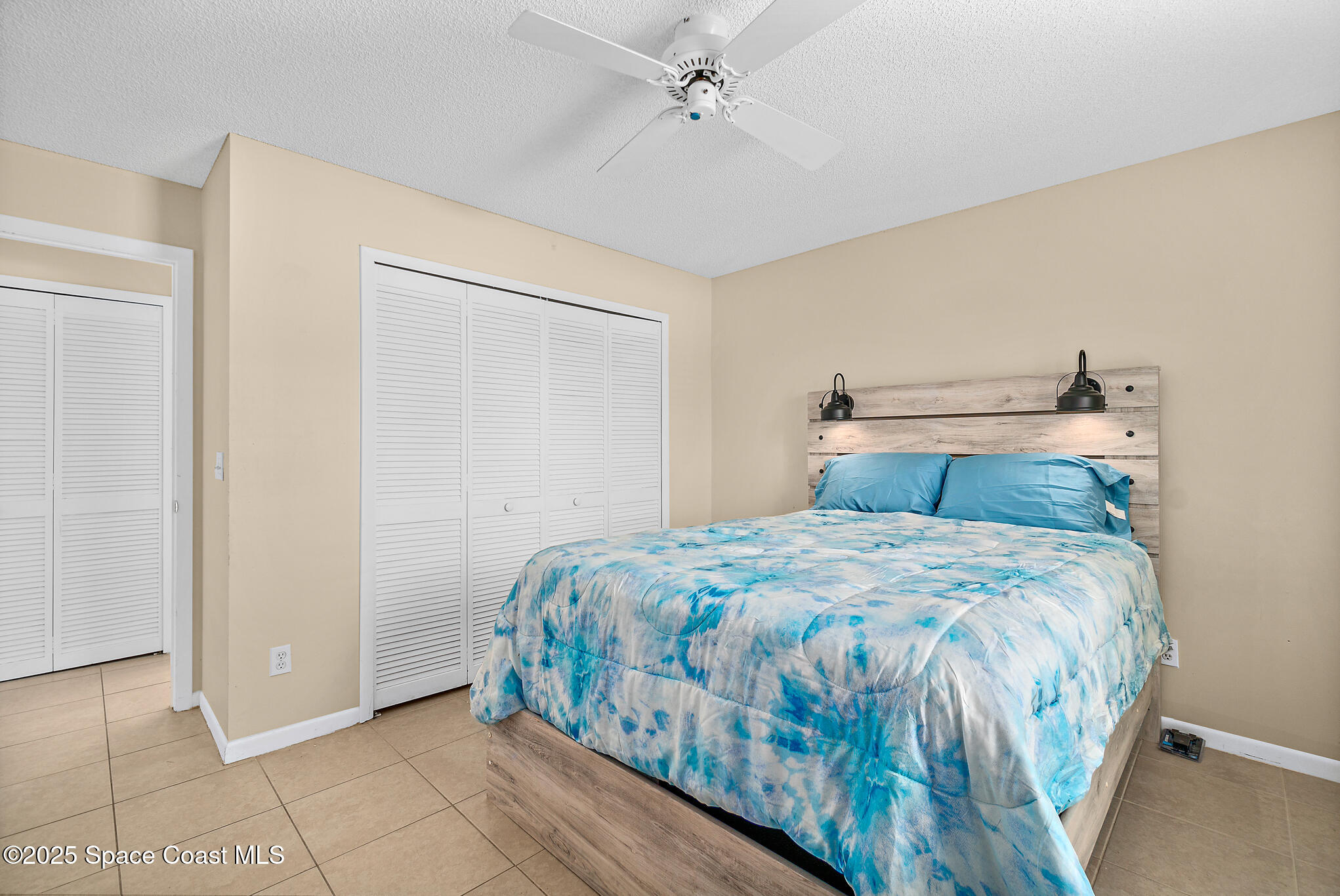 147-159 Ocean View Lane Melbourne, FL 32903 - Photo 7 of 48 a bedroom with a bed and ceiling fan