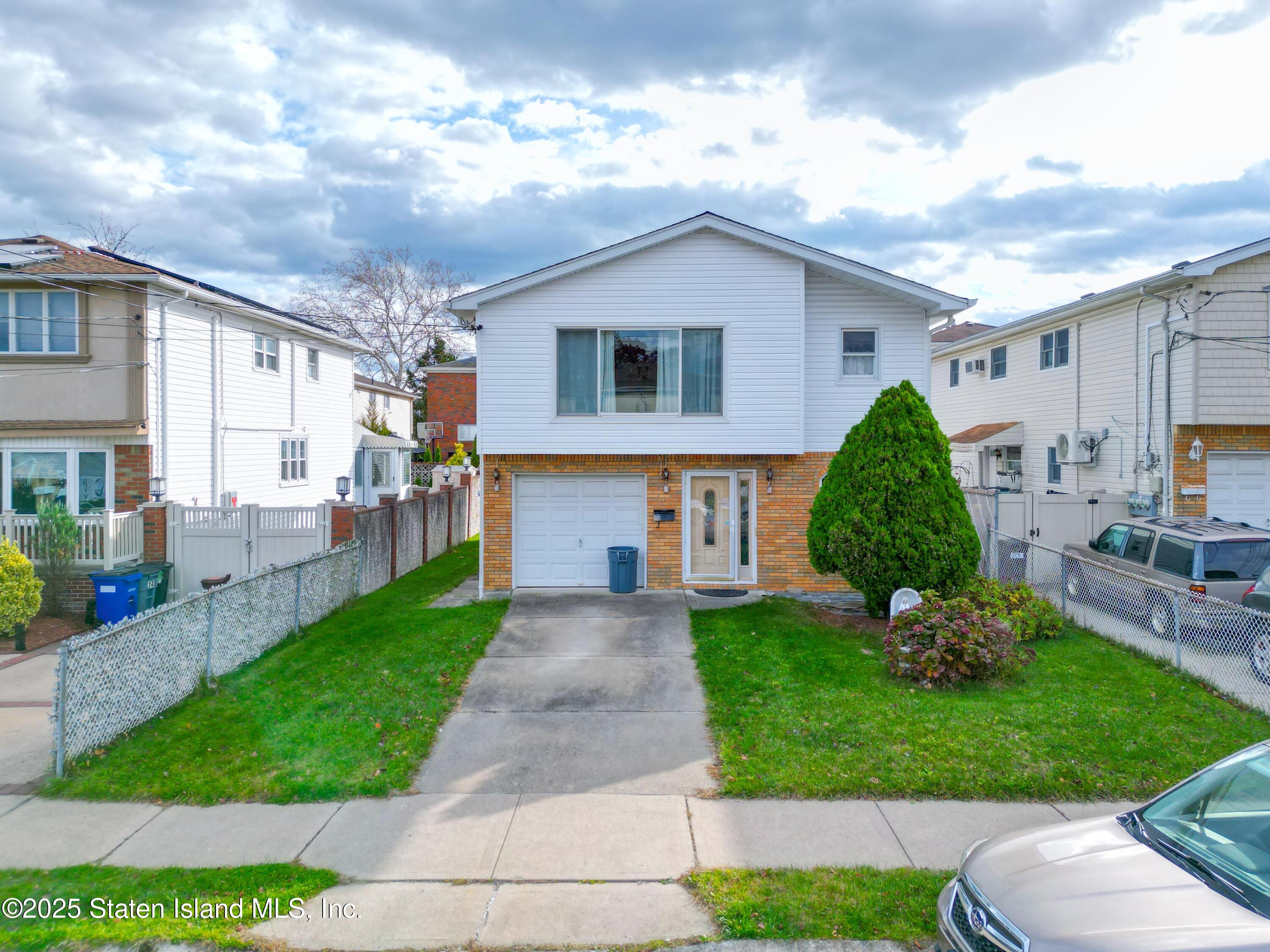 a view of a house with a yard and lawn chairs