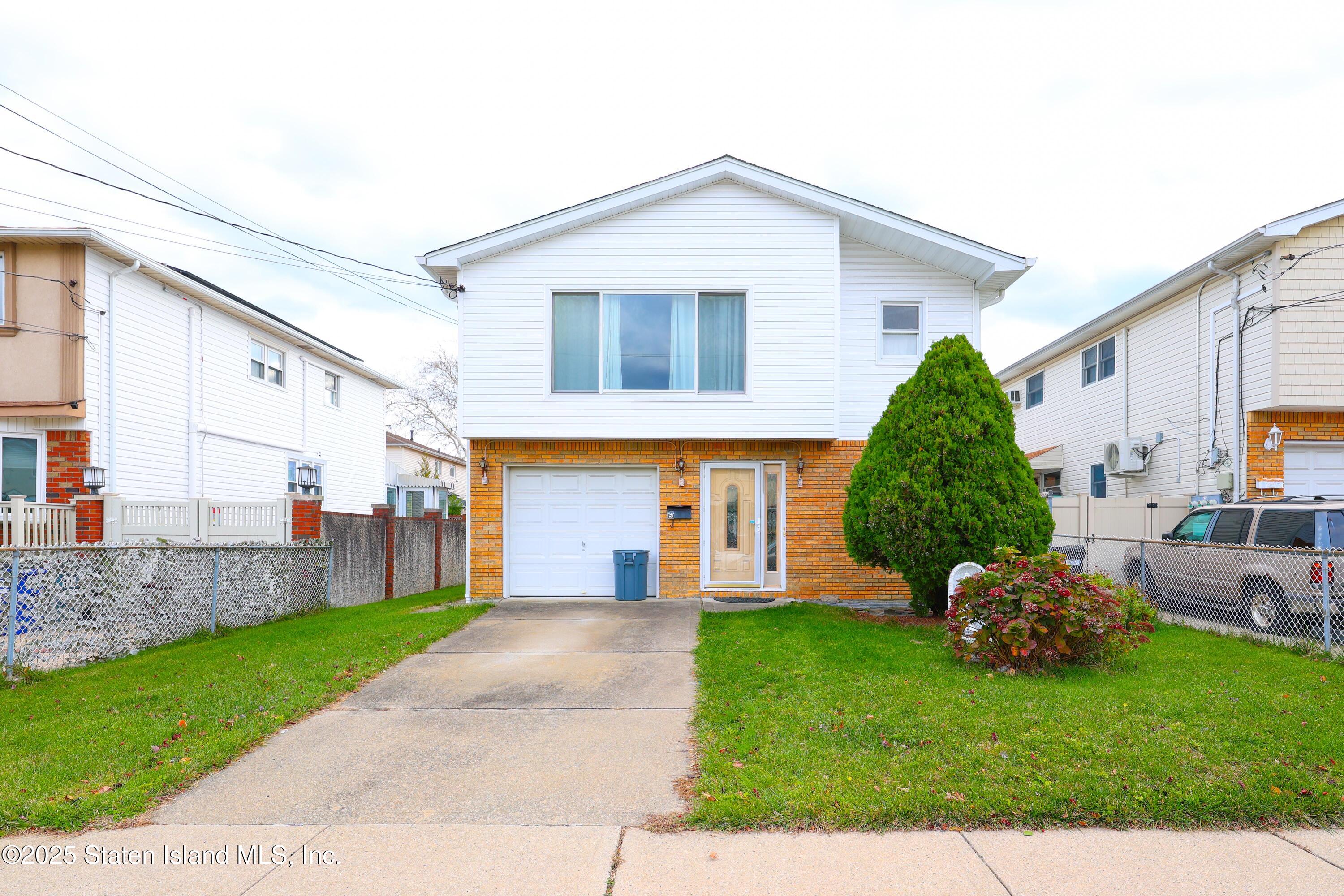 150 Stroud Avenue Staten Island, NY 10312 - Photo 2 of 12 a front view of a house with garden and plants