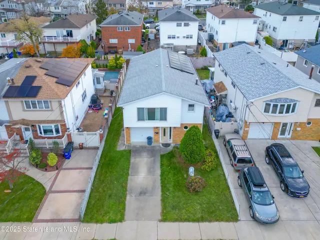 an aerial view of multiple houses with yard