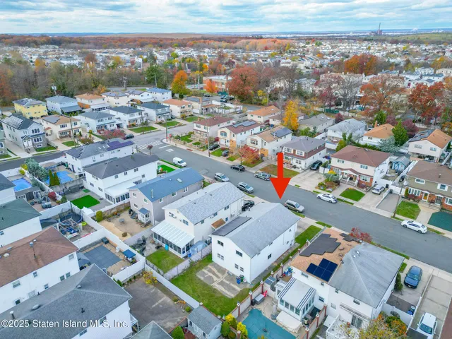 an aerial view of residential houses with outdoor space