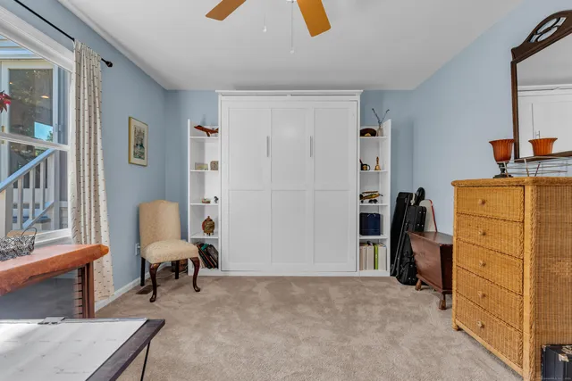 a living room with furniture and a dresser