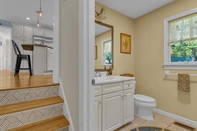 a bathroom with a sink a toilet and a mirror