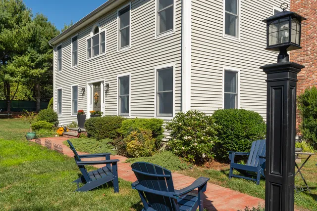 a view of a house with backyard and sitting area