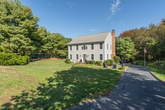 a view of a house with swimming pool and sitting area