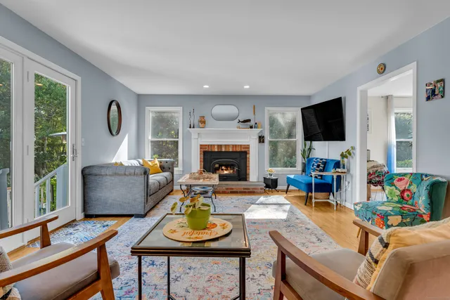 a living room with furniture and a fireplace