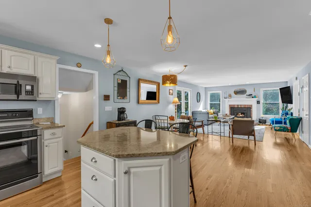 a kitchen with a table chairs refrigerator and cabinets