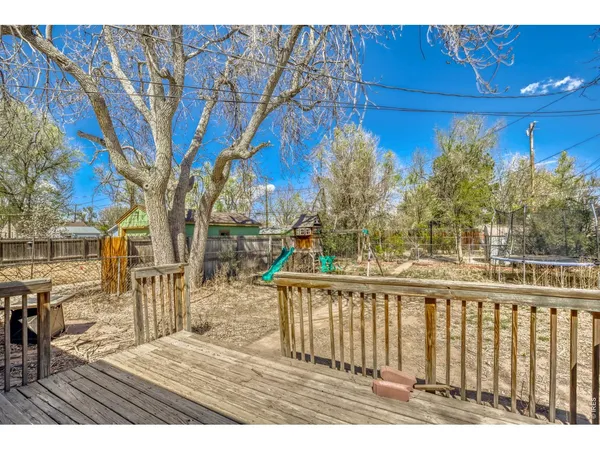 a view of a patio with wooden fence