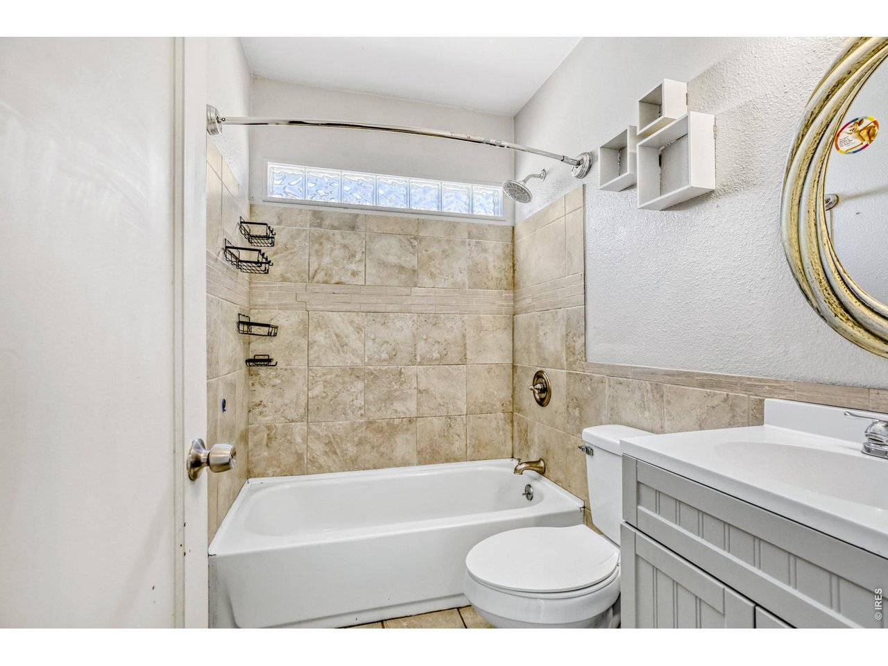 1807 7th Street Greeley, CO 80631 - Photo 10 of 17 a bathroom with a sink a toilet and a bathtub