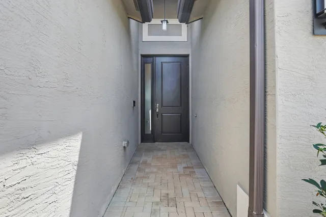 a view of a hallway with wooden floor and a hallway