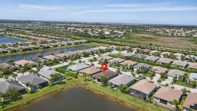an aerial view of a house with a yard and lake view