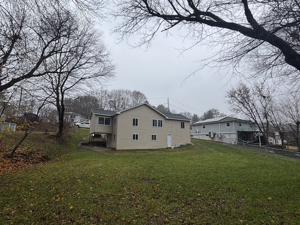 11 Williams Street Dudley, MA 01571 - Photo 2 of 16 a view of a yard with a large tree