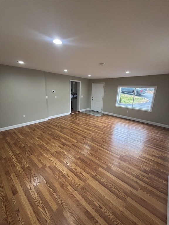 11 Williams Street Dudley, MA 01571 - Photo 3 of 16 an empty room with wooden floor and windows