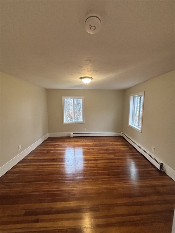 11 Williams Street Dudley, MA 01571 - Photo 10 of 16 a view of empty room with wooden floor and fan
