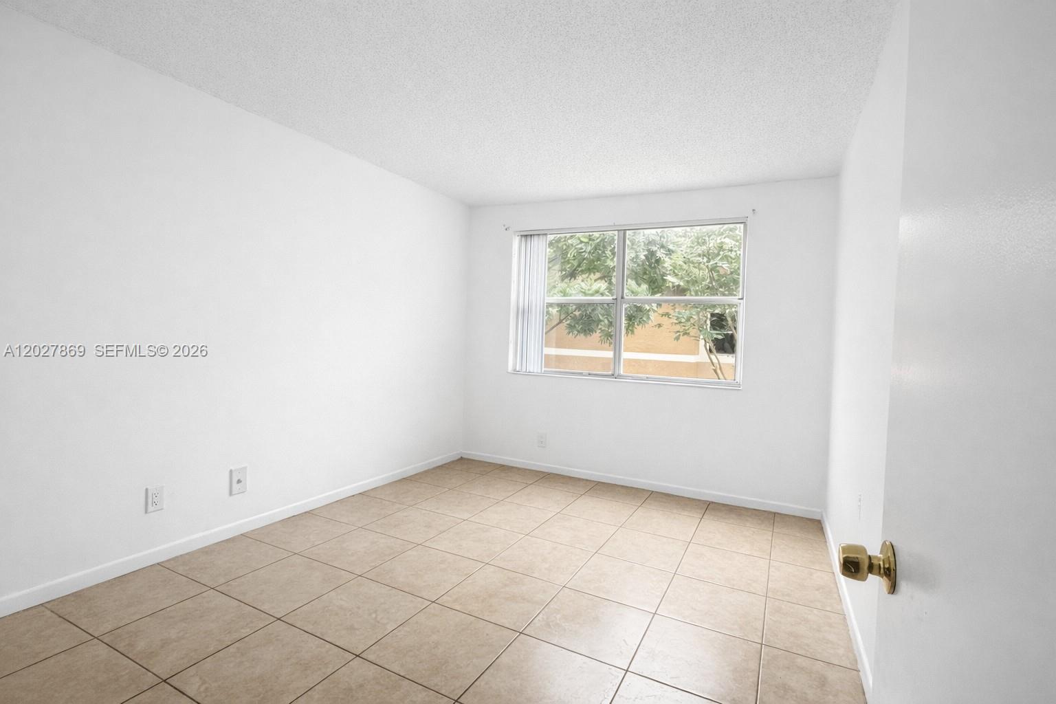 8761 Wiles Road, Unit 206 Coral Springs, FL 33067 - Photo 13 of 26 an empty room with windows
