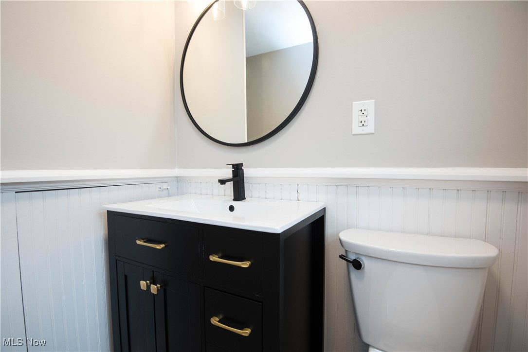 7003 Brecksville Road Independence, OH 44131 - Photo 14 of 35 Half bathroom with vanity and wainscoting