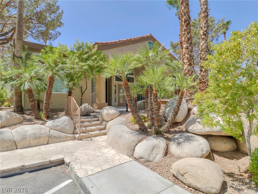 3145 East Flamingo Road, Unit 2129 Las Vegas, NV 89121 - Photo 33 of 43 A gracefully designed entrance features a stone walkway and steps, leading to the inviting front of this charming desert residence.