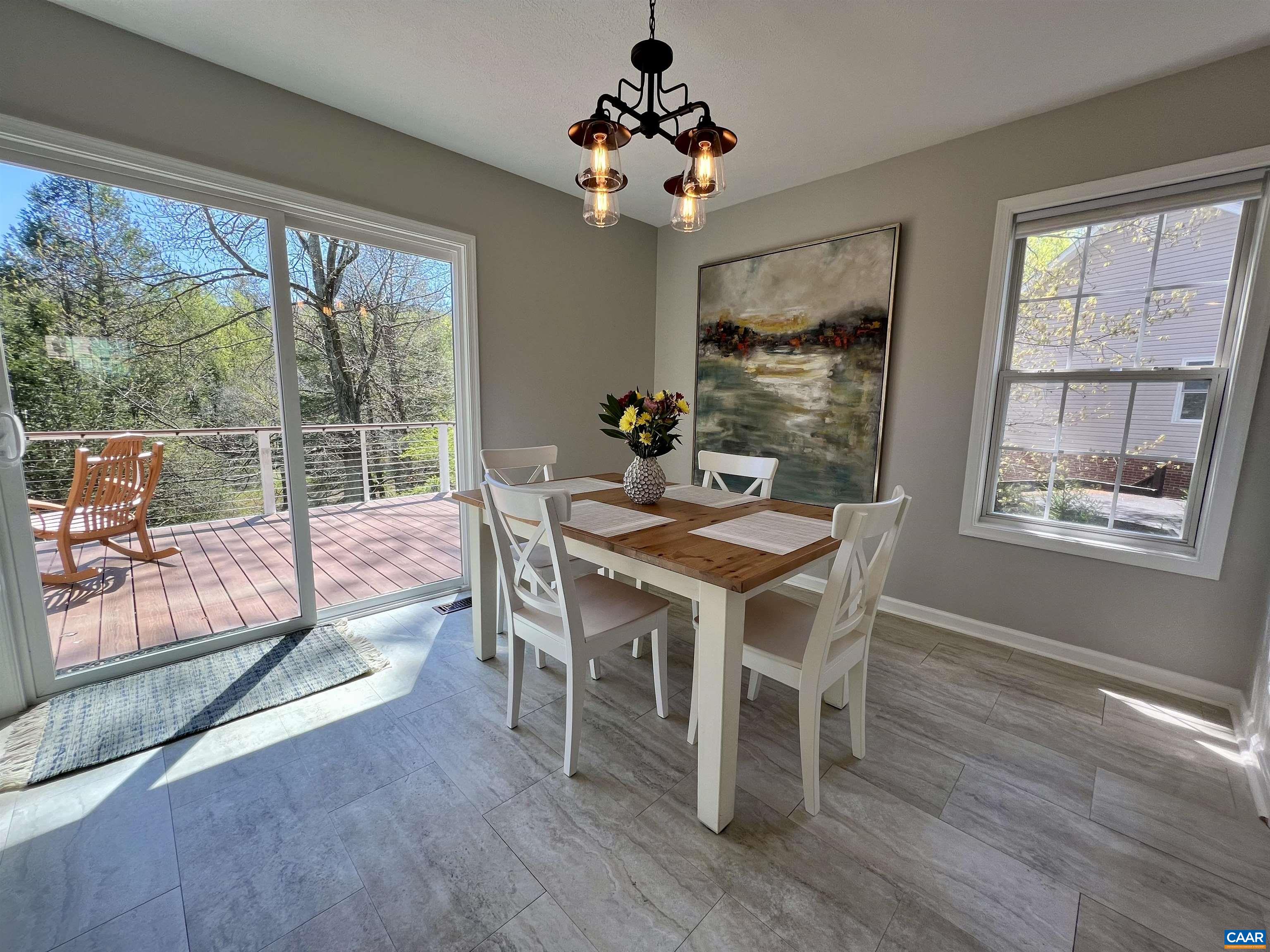 257 Starcrest Road Charlottesville, VA 22902 - Photo 17 of 65 a dining room with wooden floor a chandelier a wooden table and chairs