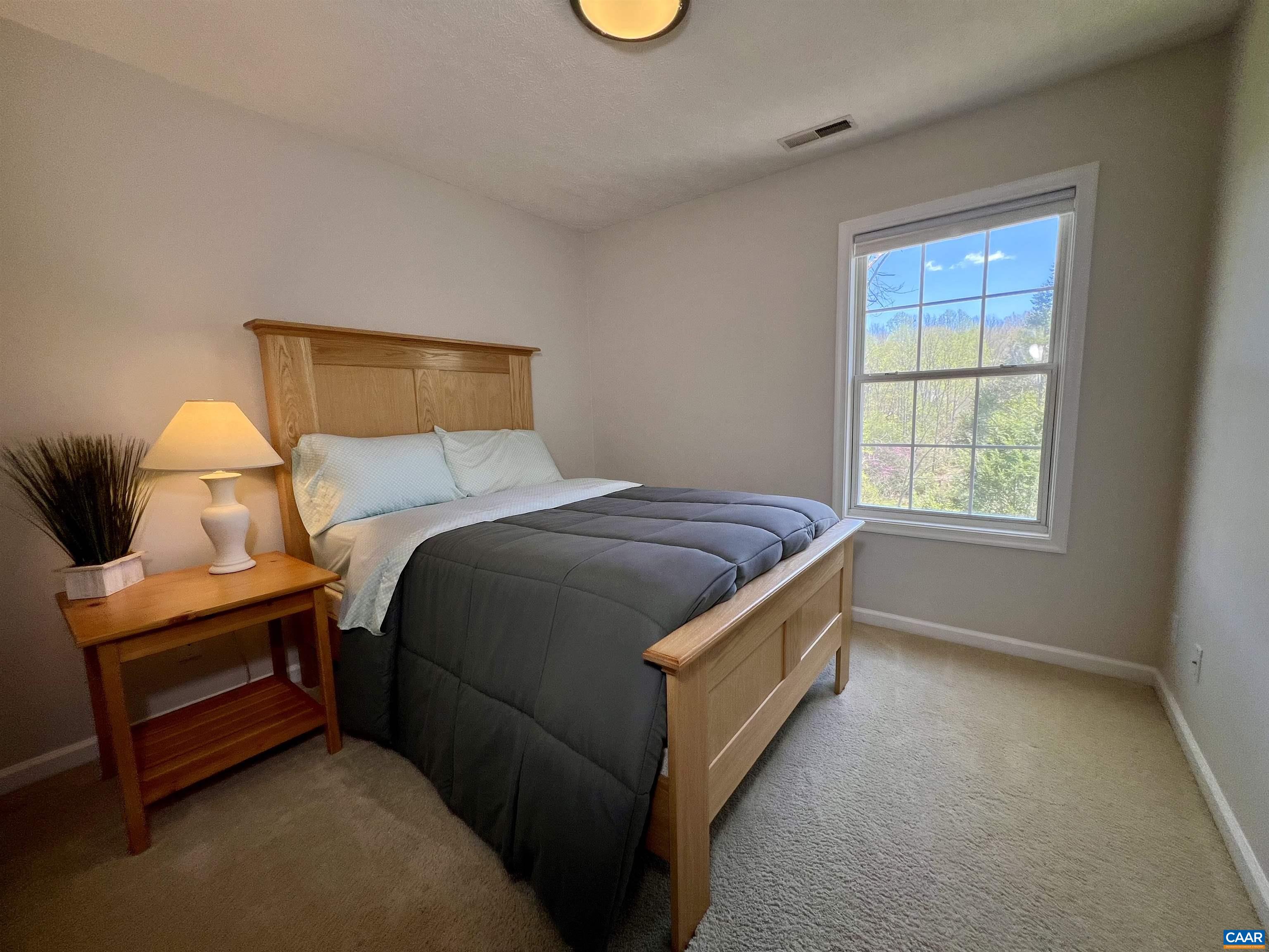 257 Starcrest Road Charlottesville, VA 22902 - Photo 33 of 65 a bedroom with a bed and a window