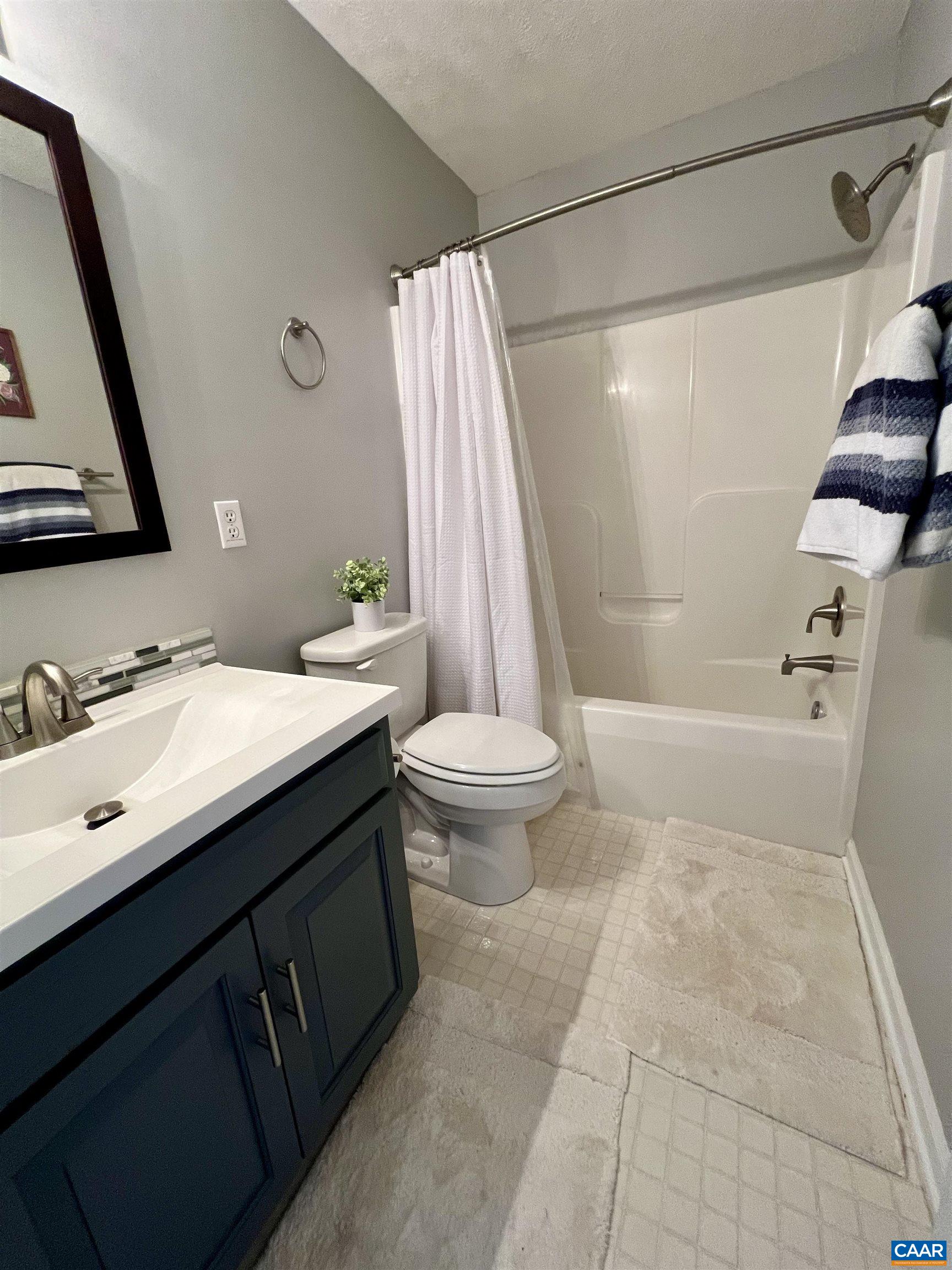 257 Starcrest Road Charlottesville, VA 22902 - Photo 34 of 65 a bathroom with a sink a toilet a mirror and shower