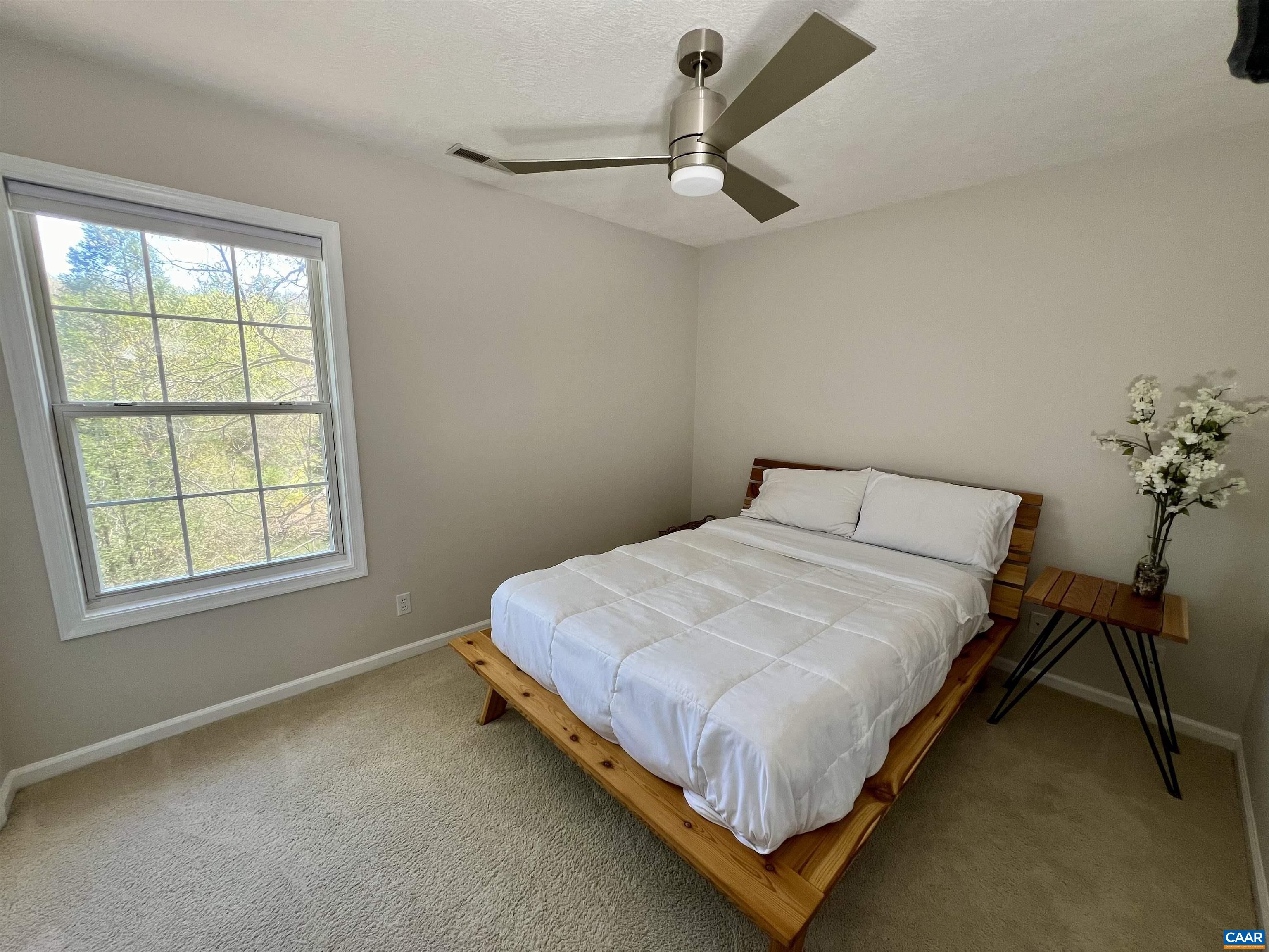 257 Starcrest Road Charlottesville, VA 22902 - Photo 35 of 65 a bed sitting in a bedroom next to a window