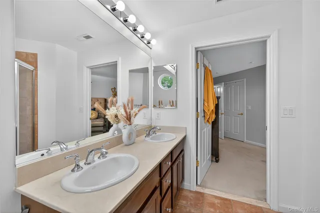 a bathroom with a sink double vanity and a mirror