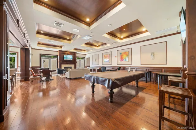 a living room with furniture pool table and a large window