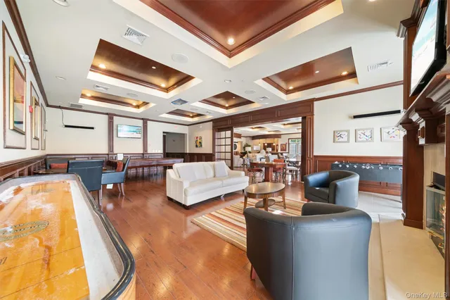 a living room with fireplace furniture and a large window