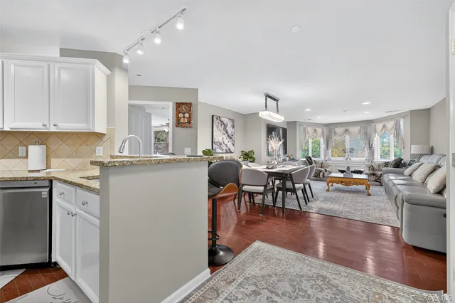 a living room with lots of furniture and kitchen view