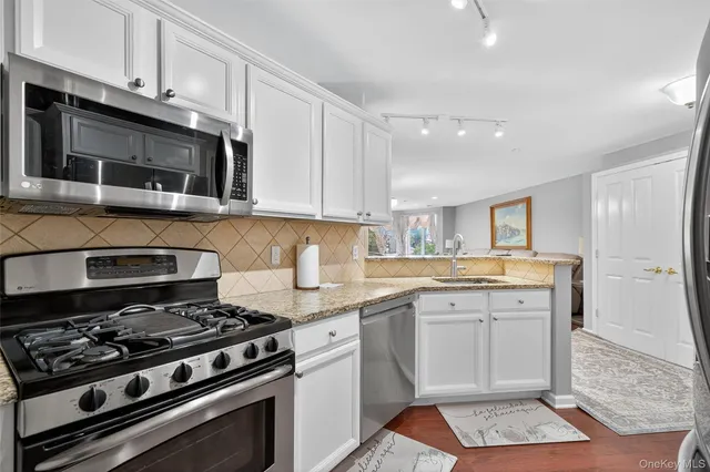 a kitchen with a stove and white cabinets