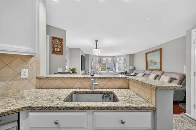 a kitchen with a sink and a wooden floor