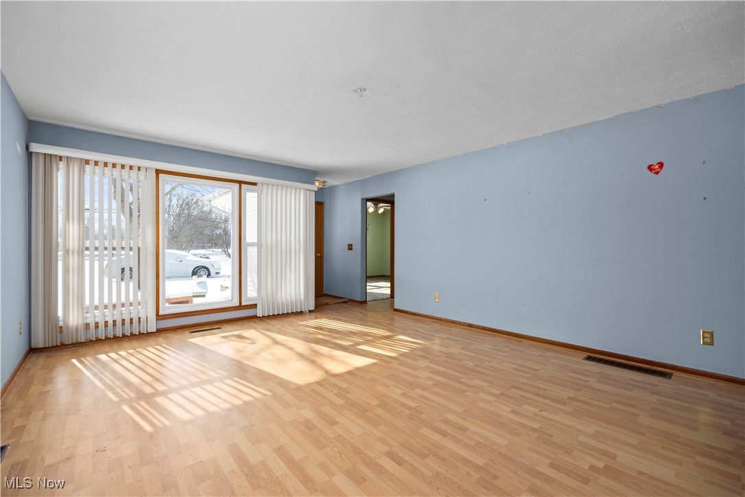 14015 West Lake Road Vermilion, OH 44089 - Photo 14 of 50 Unfurnished room featuring light wood-type flooring and baseboards