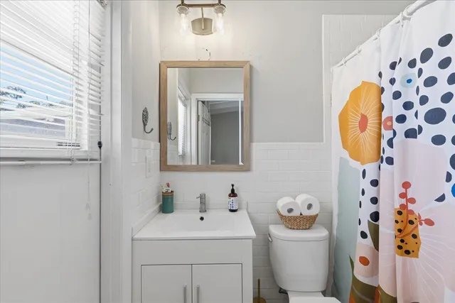 a bathroom with a sink toilet and mirror