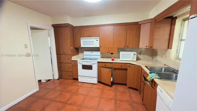a kitchen with a stove sink and cabinets