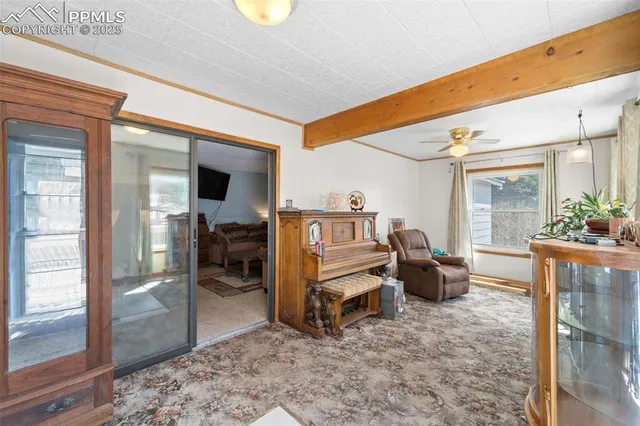 a living room with furniture a rug and a large window
