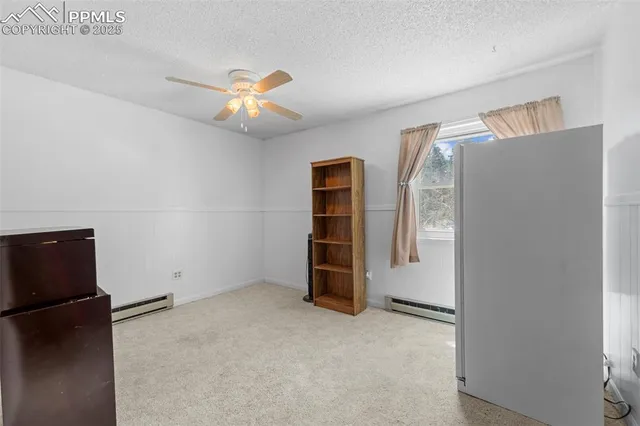 a view of an empty room with closet and a window