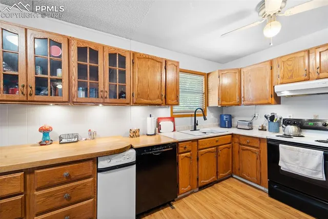 a kitchen with stainless steel appliances granite countertop a sink stove and cabinets