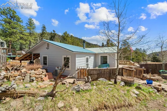 a backyard of a house with table and chairs