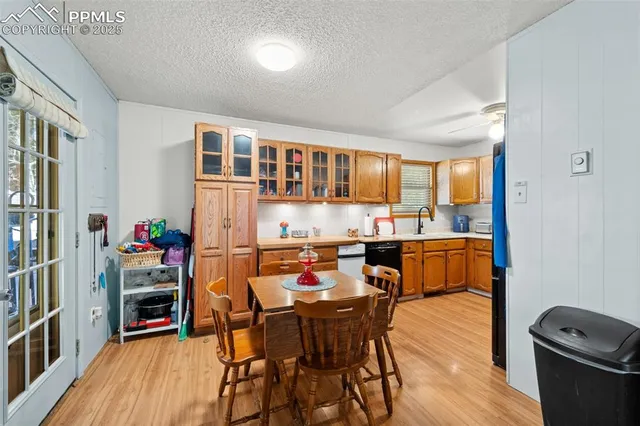 a dining room with a table chairs and a kitchen view