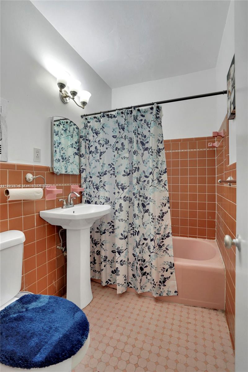 300 Northeast 48th Street Miami, FL 33137 - Photo 13 of 31 a bathroom with a sink a bath tub and a shower