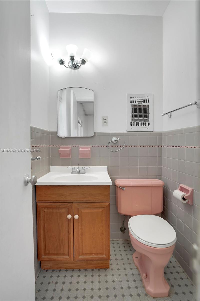 300 Northeast 48th Street Miami, FL 33137 - Photo 19 of 31 a bathroom with a sink a toilet and mirror