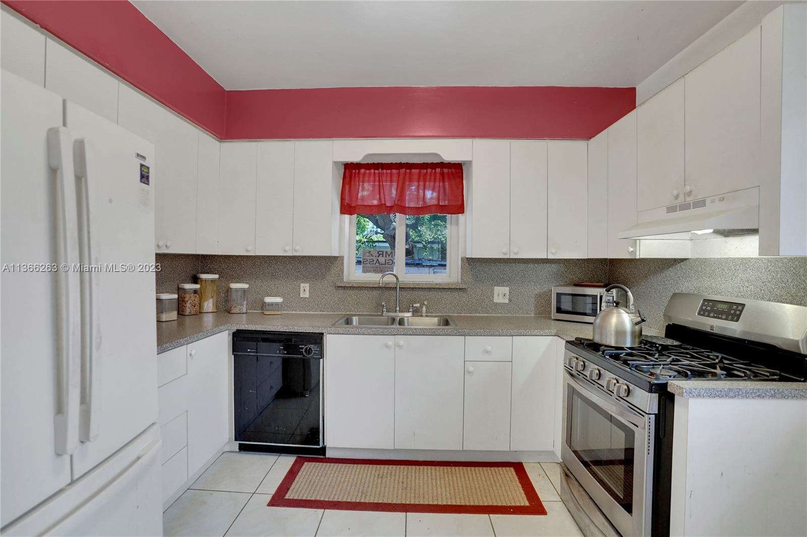 300 Northeast 48th Street Miami, FL 33137 - Photo 5 of 31 a kitchen with stainless steel appliances granite countertop a stove a sink and a refrigerator