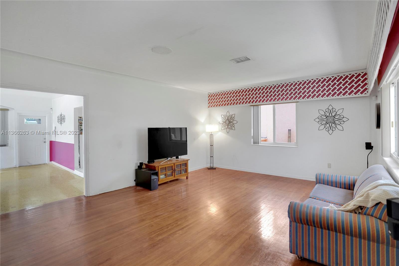 300 Northeast 48th Street Miami, FL 33137 - Photo 6 of 31 a living room with furniture and a flat screen tv