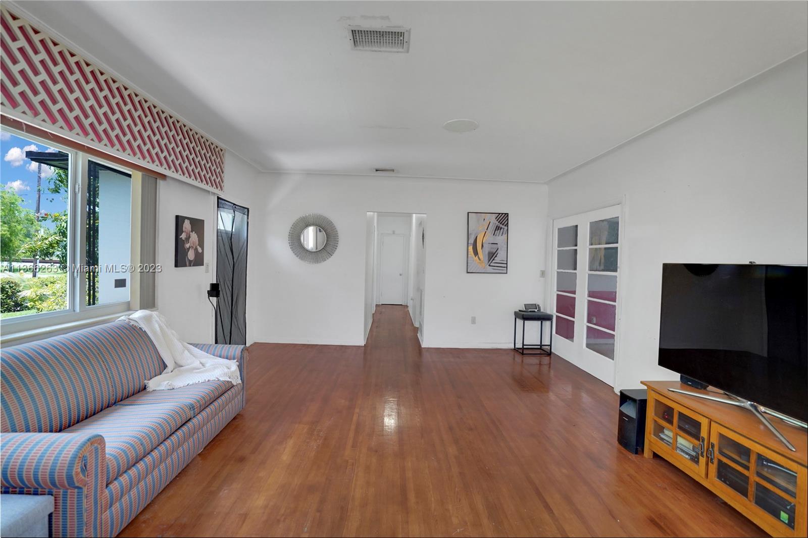 300 Northeast 48th Street Miami, FL 33137 - Photo 7 of 31 a living room with furniture and a flat screen tv