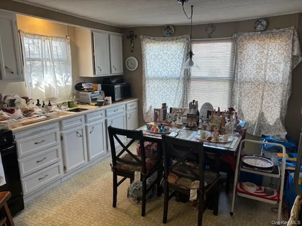 a kitchen with a table and chairs in it
