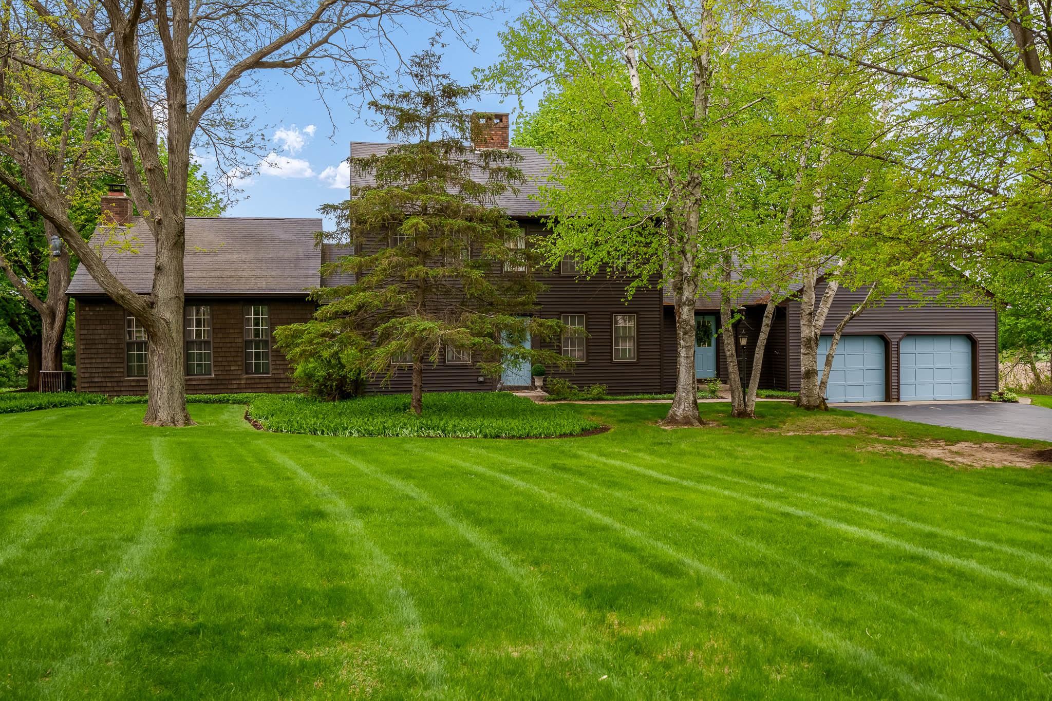 a front view of a house with a garden