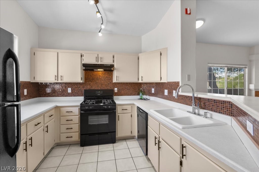 1881 West Alexander Road, Unit 1037 North Las Vegas, NV 89032 - Photo 5 of 31 A well-equipped kitchen with designer tile backsplash, an upgraded cabinet hardware provides essential amenities for everyday culinary tasks.