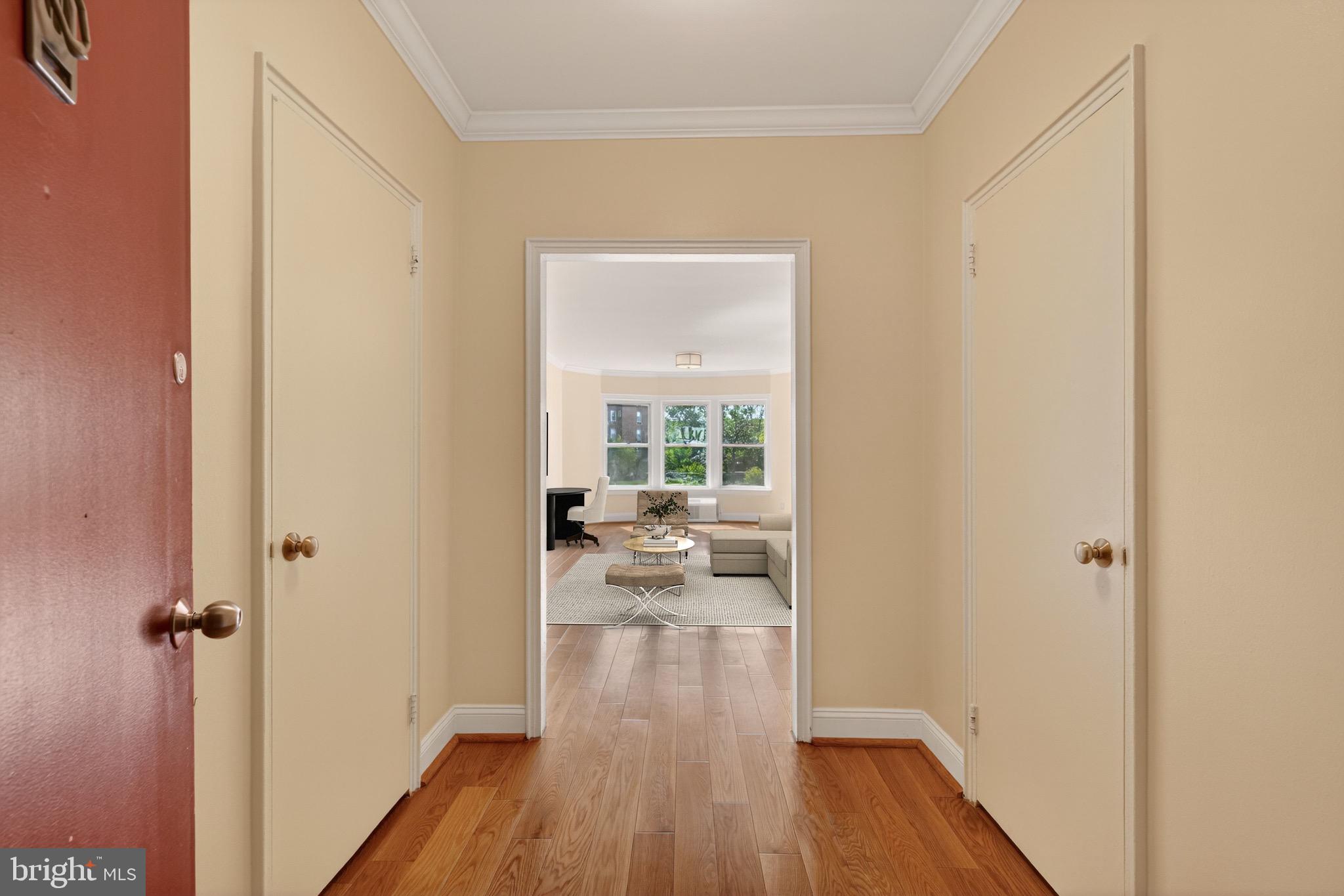 2500 Q Street Northwest, Unit 227 Washington, DC 20007 - Photo 8 of 13 a view of a hallway with wooden floor and a livingroom