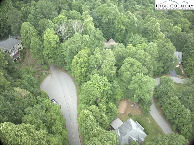 an aerial view of a house with a yard and outdoor seating